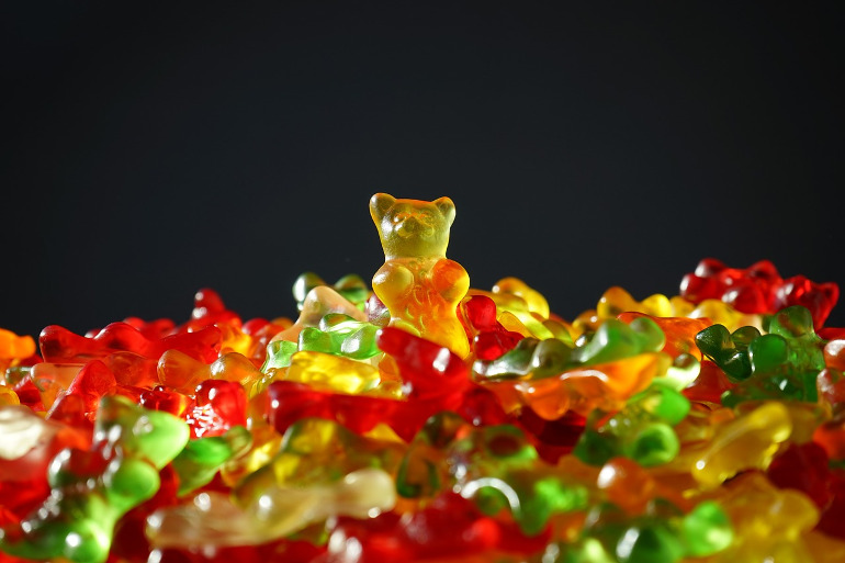 Mountain of gummy bears. A little yellow bear crowns the mountain because he is the most talented